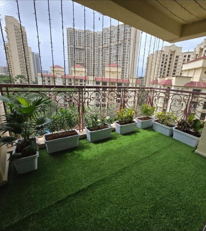Finished balcony garden with planters and green turf